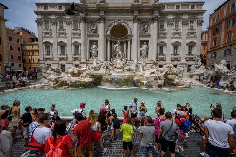 ROME, ITALY - AUGUST 10: People refresh themself because off high temperatures around 39 degrees Celsius, at Fontana Di Trevi, on August 10, 2021 in Rome, Italy. With the arrival of the 'Lucifer' anticyclone from Africa, Italy braces for the hottest week of summer. The soaring temperatures have led Italy's civil protection agency to warn of increased risks of wildfires. (Photo by Antonio Masiello/Getty Images)