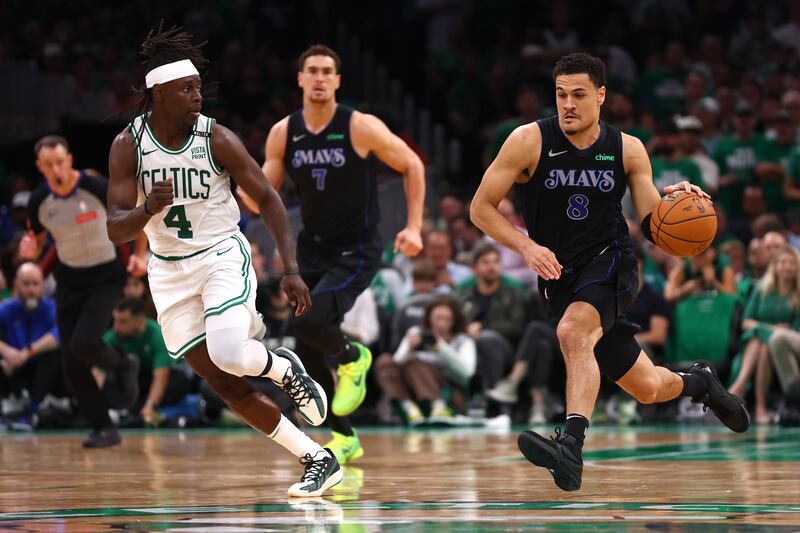 BOSTON, MASSACHUSETTS - JUNE 06: Josh Green #8 of the Dallas Mavericks drives to the basket against Jrue Holiday #4 of the Boston Celtics during the fourth quarter in Game One of the 2024 NBA Finals at TD Garden on June 06, 2024 in Boston, Massachusetts. NOTE TO USER: User expressly acknowledges and agrees that, by downloading and or using this photograph, User is consenting to the terms and conditions of the Getty Images License Agreement. (Photo by Maddie Meyer/Getty Images)
