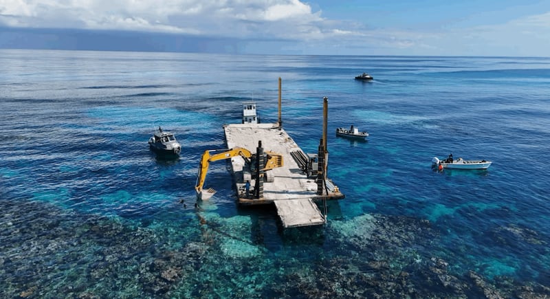 Imagen captada por el equipo de limpieza de Trailer Bridge de la excavadora de limpieza recuperando escombros en las Bahamas