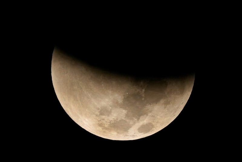 A lunar eclipse graces the night sky during the first blood moon of the year, in Brasilia, Brazil, Sunday, May 15, 2022. (AP Photo/Eraldo Peres)