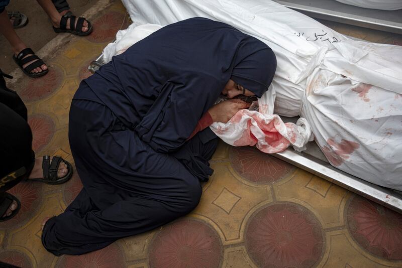 Una mujer llora a su esposo e hijo muertos en un bombardeo del ejército israelí en la Franja de Gaza, en el hospital de Jan Yunis.