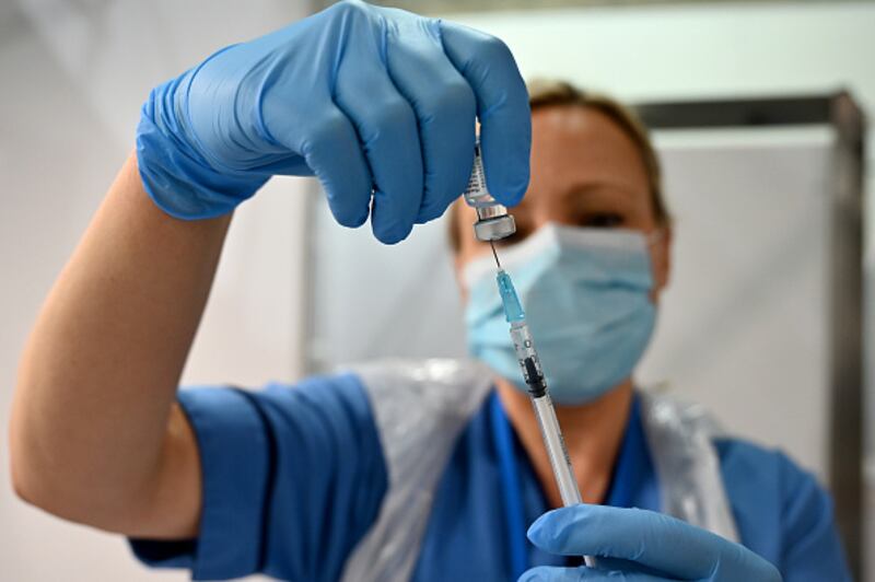GLASGOW, SCOTLAND - DECEMBER 08: Grace Thomson receives the coronavirus vaccine from Paula McMahon at the Louisa Jordan Hospital as the roll out begins on December 8, 2020 in Glasgow, Scotland. A batch of 65,000 doses of the Pfizer BioNTech vaccine arrived in the country at the weekend, it will be offered to all those over the age of eighteen a total of about 4.4 million people in Scotland. (Photo by Jeff J Mitchell - Pool /Getty Images)