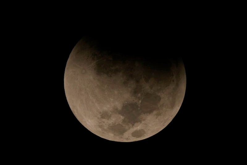 A lunar eclipse graces the night sky during the first blood moon of the year, in Brasilia, Brazil, Sunday, May 15, 2022. (AP Photo/Eraldo Peres)