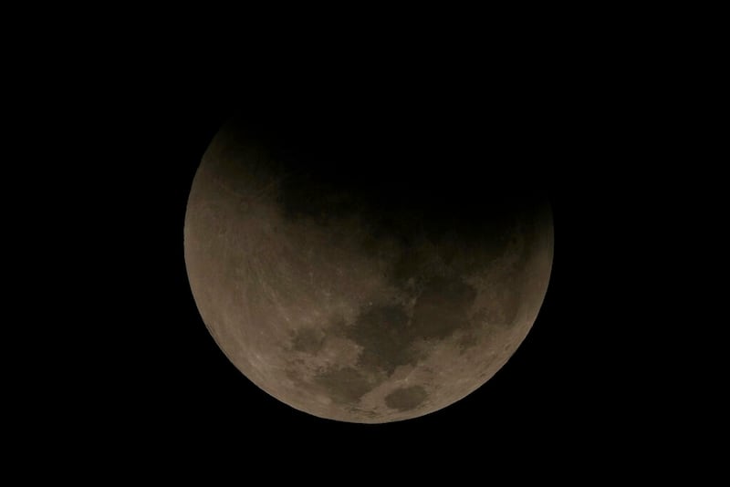 A lunar eclipse graces the night sky during the first blood moon of the year, in Brasilia, Brazil, Sunday, May 15, 2022. (AP Photo/Eraldo Peres)