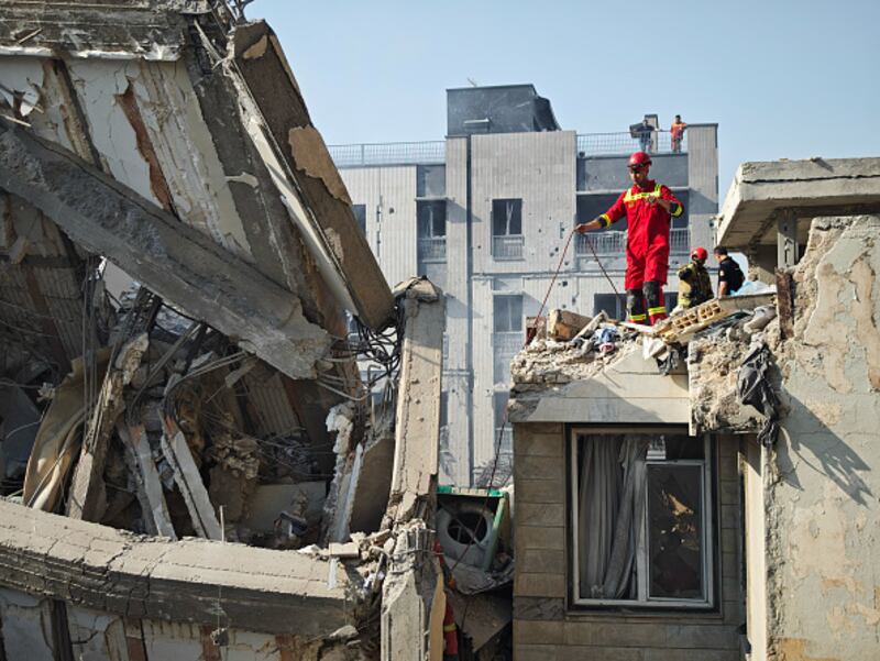 La gente observa los daños sufridos por los edificios tras los ataques aéreos israelíes el 13 de junio de 2025 en Teherán, Irán.