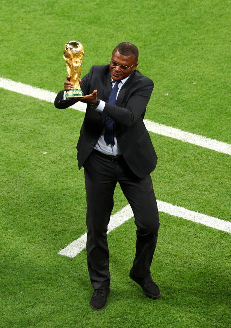 AL KHOR, QATAR - NOVEMBER 20: Marcel Desailly brings out the FIFA World Cup Trophy prior to the FIFA World Cup Qatar 2022 Group A match between Qatar and Ecuador at Al Bayt Stadium on November 20, 2022 in Al Khor, Qatar. (Photo by Elsa/Getty Images)