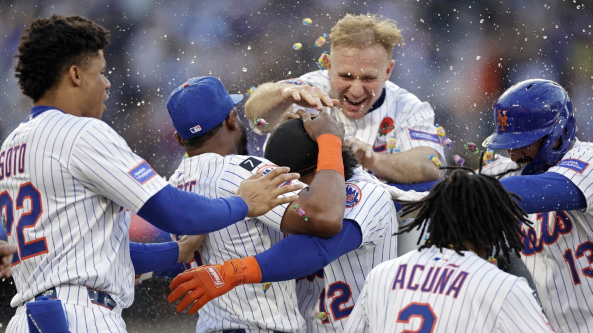 El puertorriqueño Francisco Lindor es felicitado por sus compañeros de los Mets de Nueva York tras batear un elevado de sacrificio para darle el triunfo en la novena a su equipo ante los Medias Blancas de Chicago el lunes 26 de mayo del 2025.