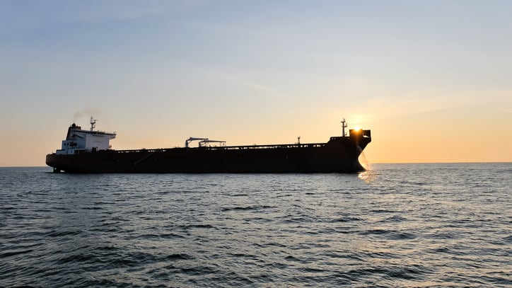 Crude oil tanker in the sea at sunset.