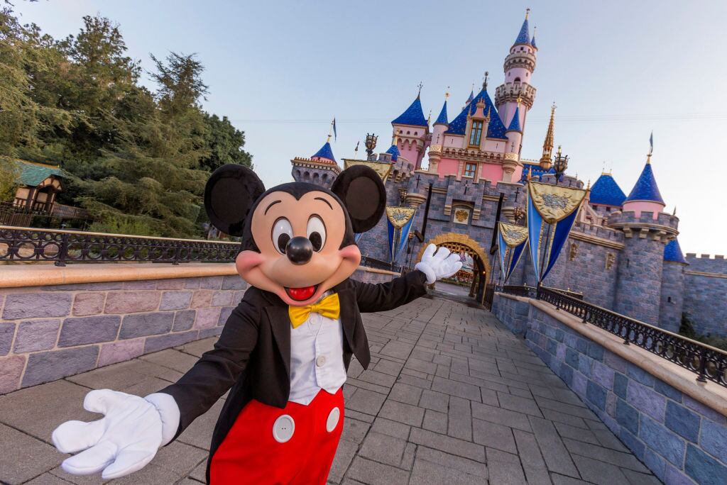 ANAHEIM, CA - AUGUST 27: Mickey Mouse poses in front of Sleeping Beauty Castle at Disneyland Park on August 27, 2019 in Anaheim, California. Disneyland plans to reopen on April 30, 2021. (Photo Joshua Sudock/Walt Disney World Resorts via Getty Images)