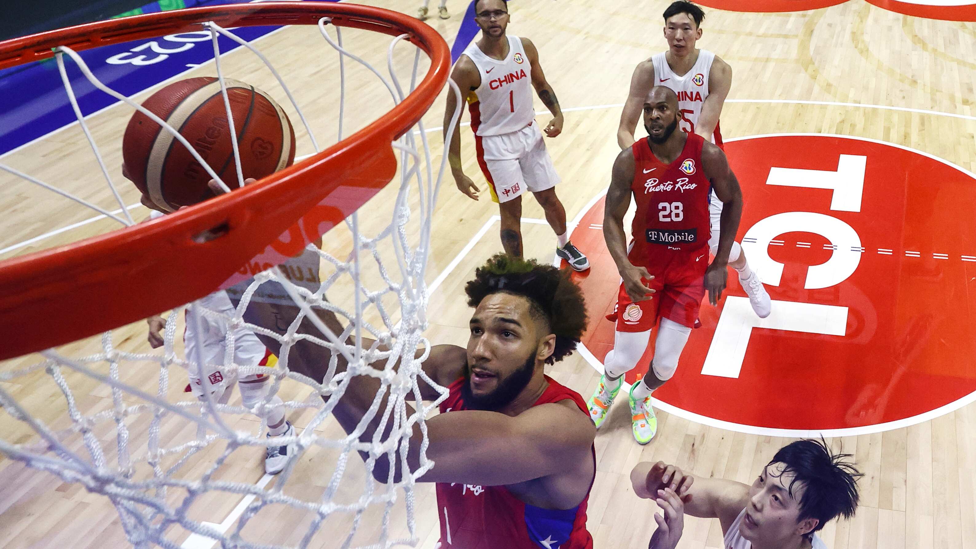 George Conditt (1) of Puerto Rico drives to the basket against Hu Mingxuan (3) of China in the second half during the FIBA Basketball World Cup Group B game at Araneta Coliseum on Monday August 30, 2023 in Manila, Philippines. (Yong Teck Lim/Pool Photo via AP)