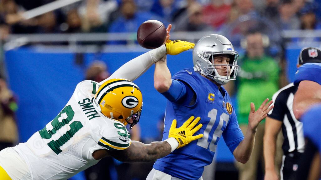 Preston Smith (91), linebackers de los Packers de Green Bay, le tumba el balón de la mano al quarterback Jared Goff (16), de los Lions de Detroit, durante la primera mitad del juego de la NFL, el jueves 23 de noviembre de 2023, en Detroit. (AP Foto/Duane Burleson)
