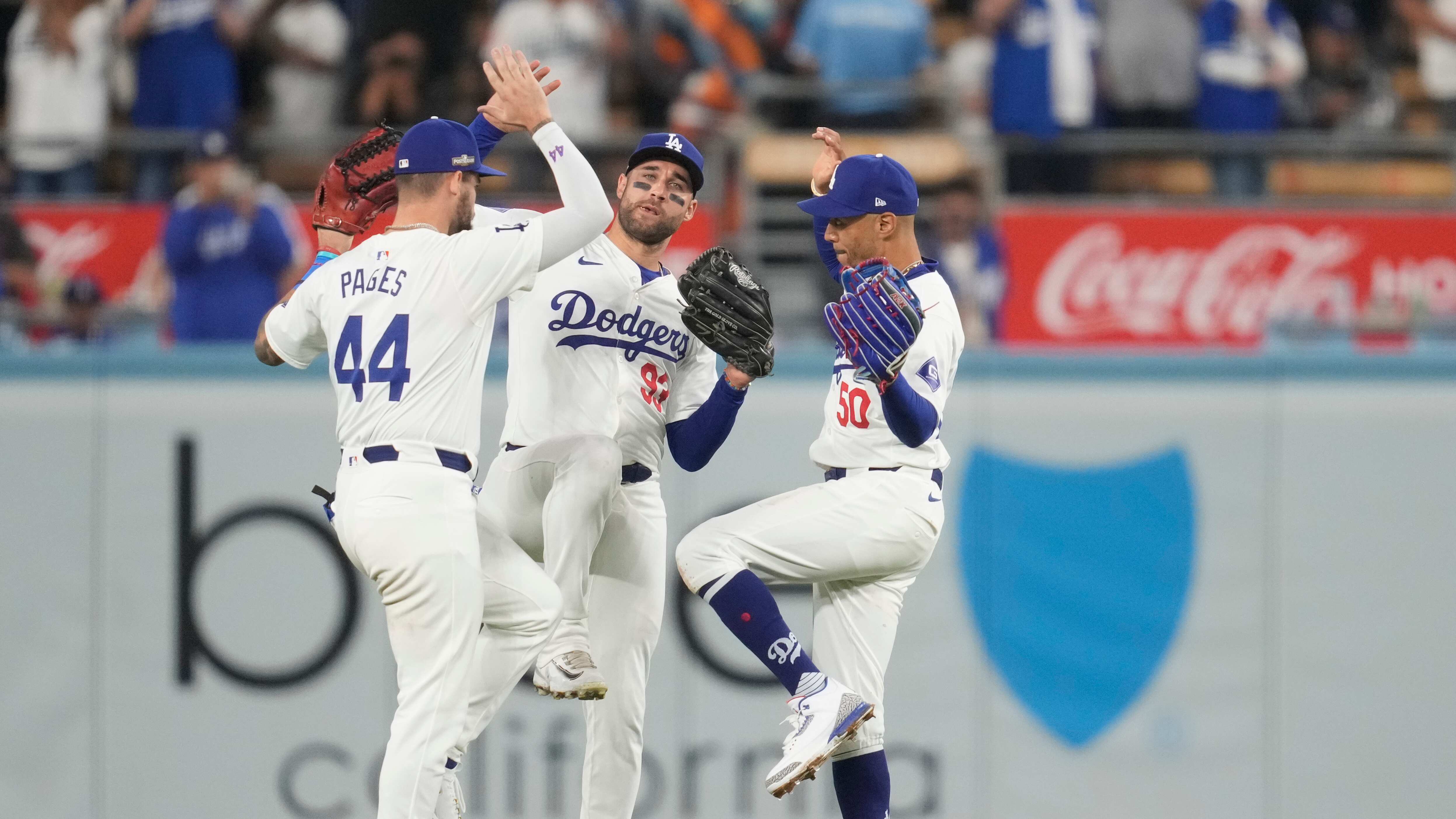 Los jardineros de los Dodgers de Los Ángeles, Andy Pages, Kevin Kiermaier y Mookie Betts celebran su victoria contra los Mets de Nueva York en el primer juego de la Serie de Campeonato de la Liga Nacional de béisbol, el domingo 13 de octubre de 2024, en Los Ángeles. (Foto AP/Ashley Landis)