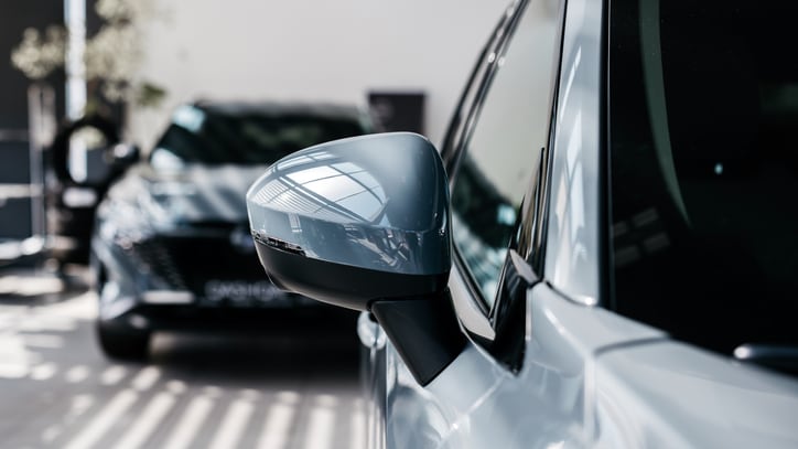Close-up of new cars in the showroom of the dealership.