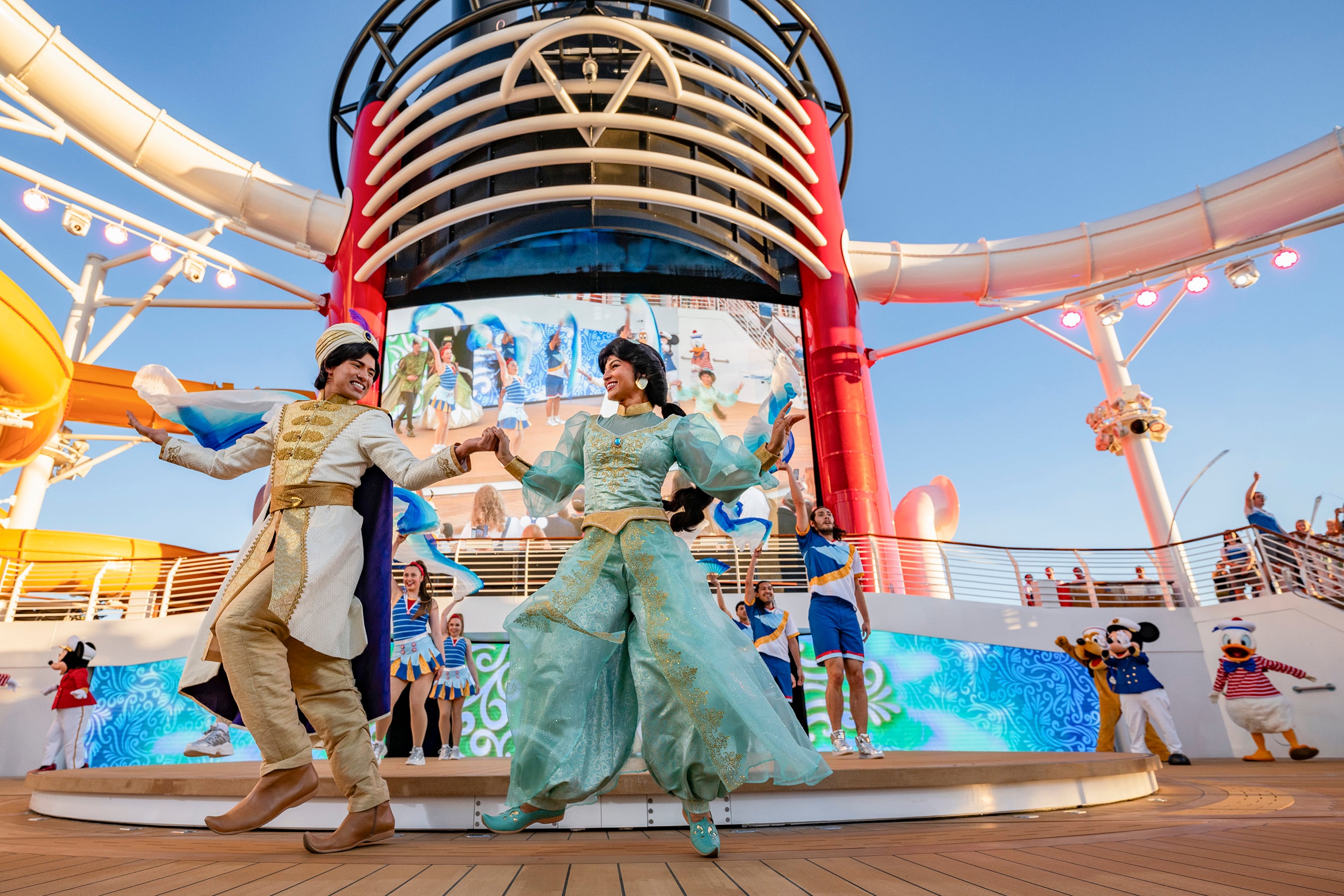 Disney characters join guests on the upper decks for a celebratory sail away party to kick off each voyage on the Disney Treasure. (Kent Phillips, photographer)