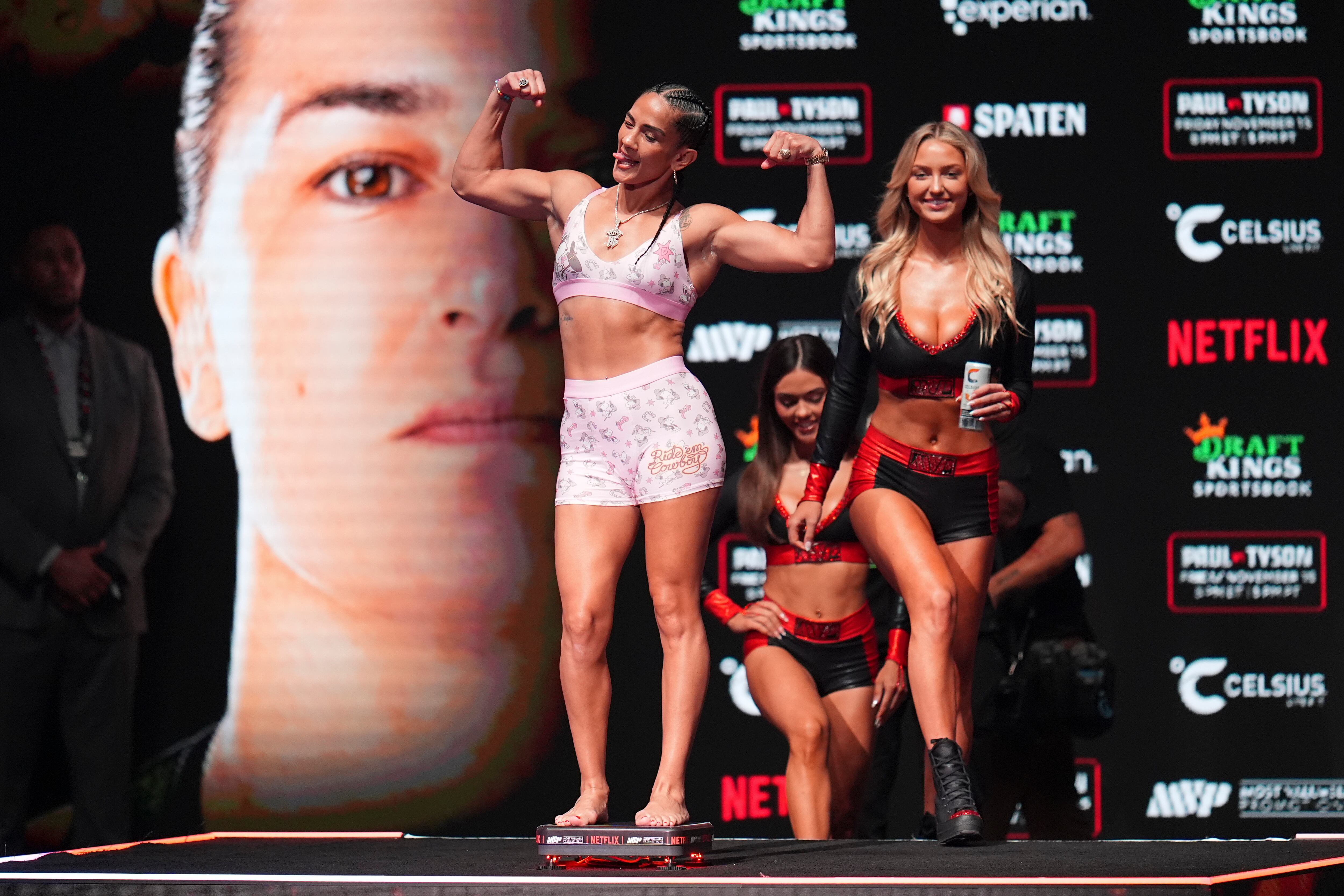 Amanda Serrano steps on the scale during a weigh-in ahead of her undisputed super lightweight title bout against Katie Taylor, Thursday, Nov. 14, 2024, in Irving, Texas. (AP Photo/Julio Cortez)