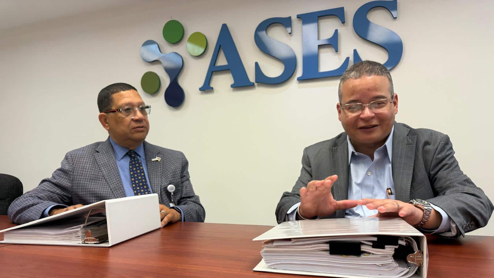 Carlos Santiago y Víctor Ramos frente a logo de ASES.