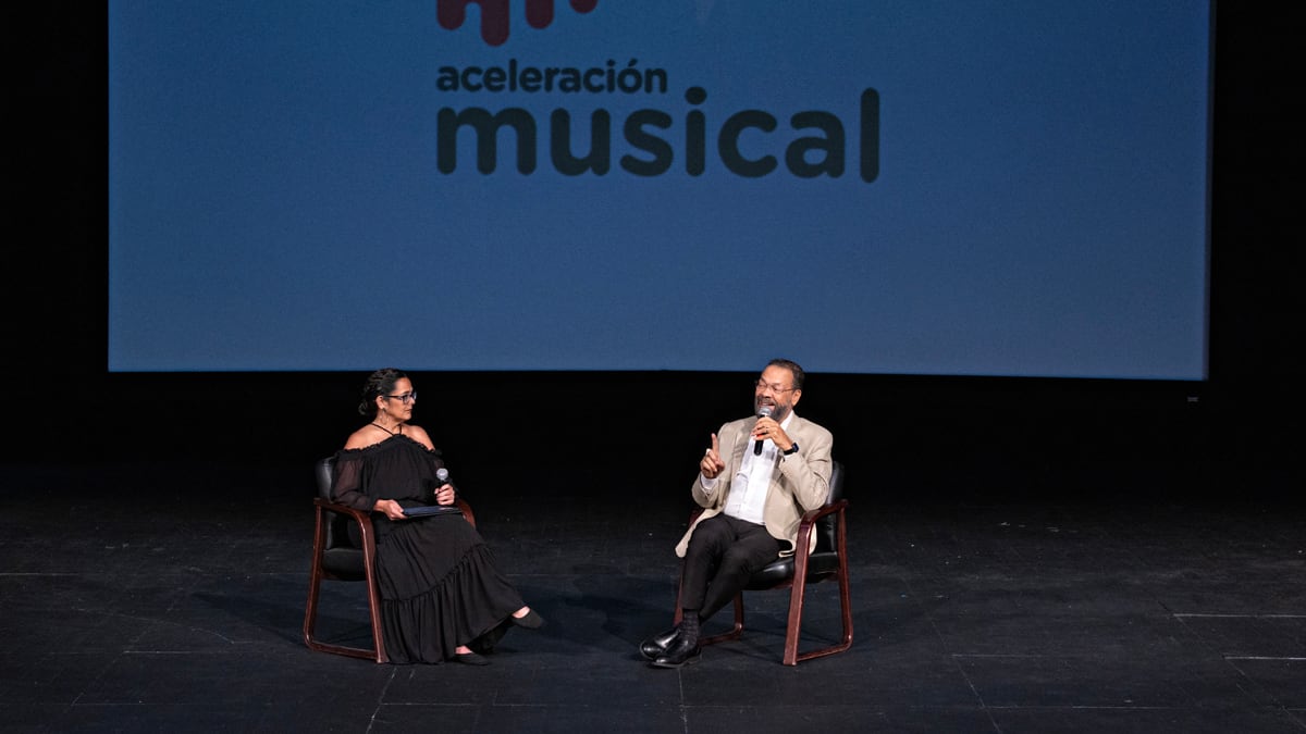 Ángel “Cucco” Peña y Leila Martínez, maestra de la escuela Libre de Música de San Juan, conversan con los estudiantes del internado durante la actividad de bienvenida.