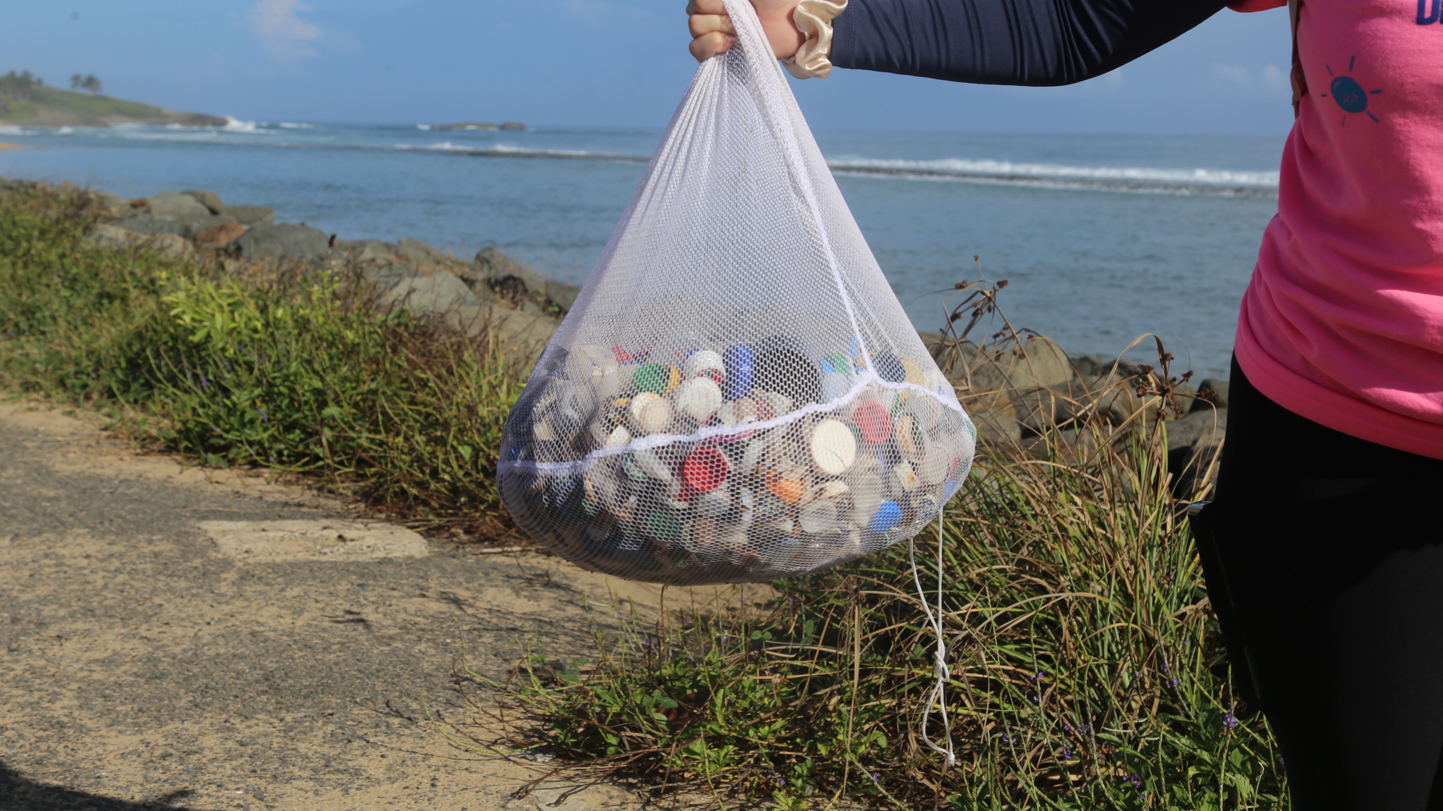 Capitana de Costas muestra una bolsa de microplásticos recolectada durante la 21ma. edición de la Limpieza Internacional de Costas.