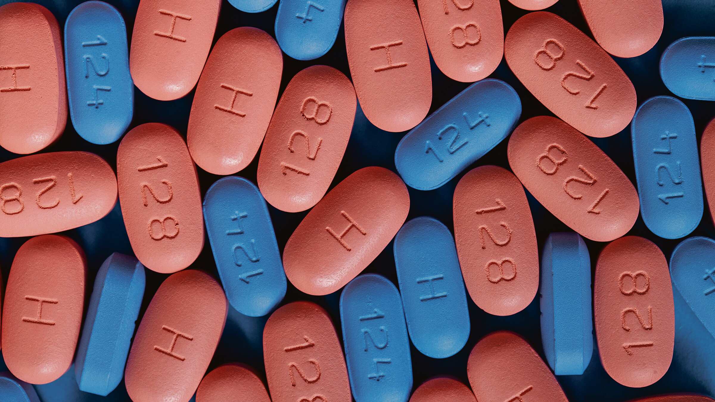 Pildoras rosas y azules. Algunas tienen una H, otras los números 128 o 124.