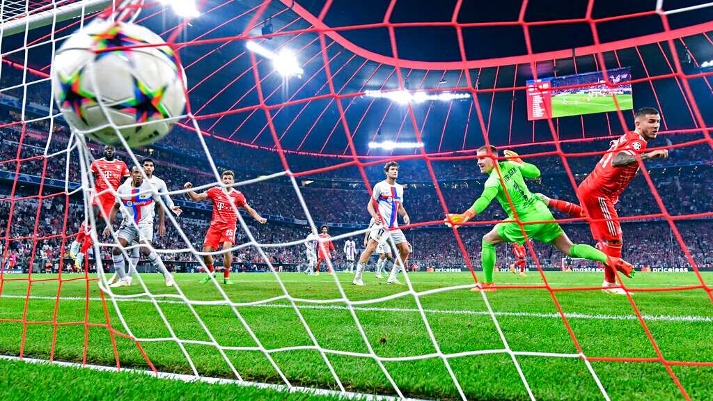 Munich's Lucas Hernández, right, scores a goal past Barcelona goalkeeper Marc-André ter Stegen (1) during a Champions League, group C soccer match between Bayern Munich and Barcelona at the Allianz Arena in Munich, Germany, Tuesday, Sept. 13, 2022. (Sven Hoppe/dpa via AP)