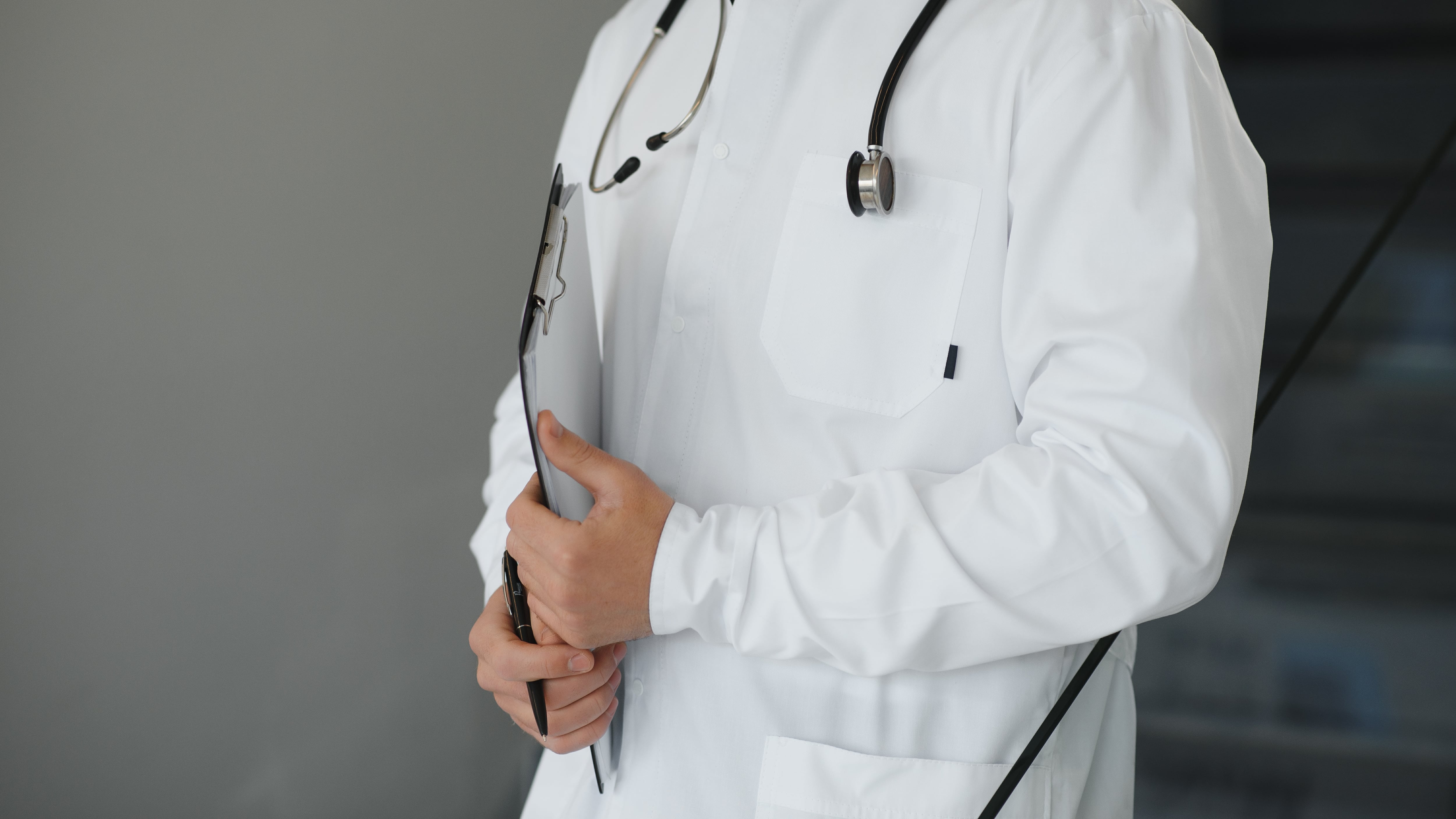 Retrato de un médico en uniforme de pie en el pasillo de la clínica