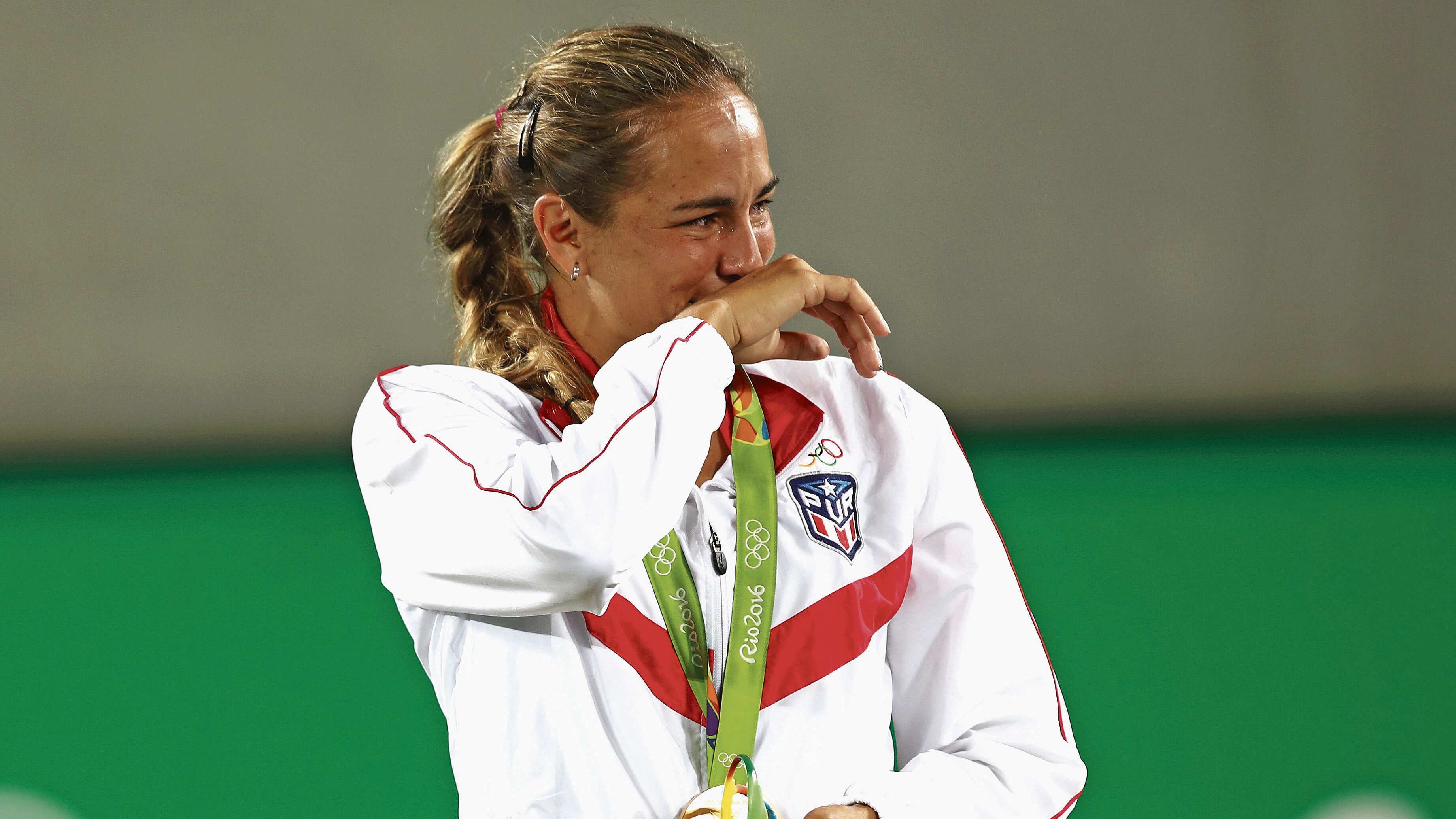RIO DE JANEIRO, BRAZIL - AUGUST 13: Gold medalist Monica Puig of Puerto Rico reacts during the medal ceremony for Women's Singles on Day 8 of the Rio 2016 Olympic Games at the Olympic Tennis Centre on August 13, 2016 in Rio de Janeiro, Brazil. (Photo by Clive Brunskill/Getty Images)